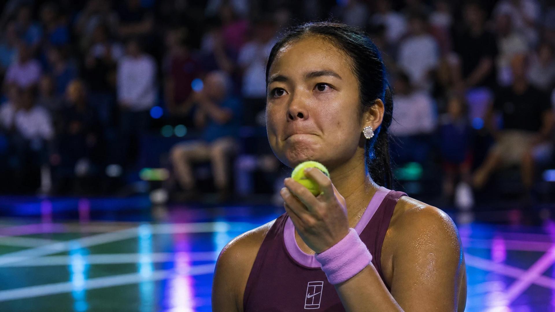 Close-up of Alex Eala preparing to serve during a tennis match.