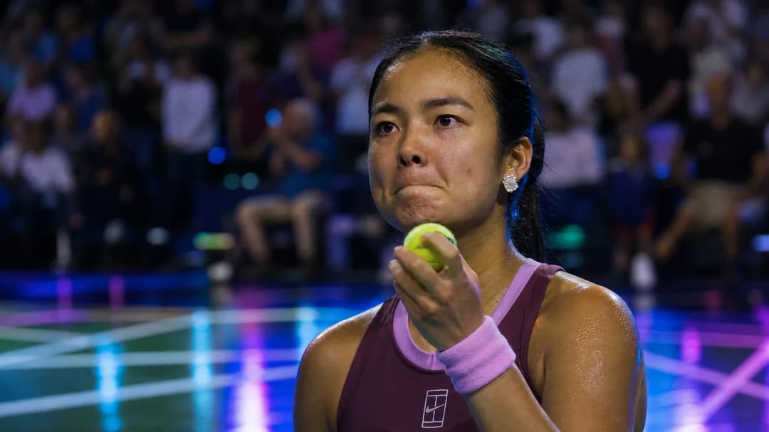 Close-up of Alex Eala preparing to serve during a tennis match.