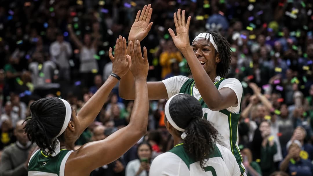 Dominique Malonga celebrating victory with teammates in a basketball arena.