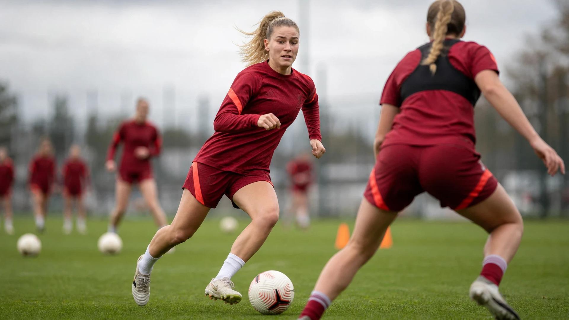 Liverpool midfielder Marie Höbinger dribbling the ball during a training session.