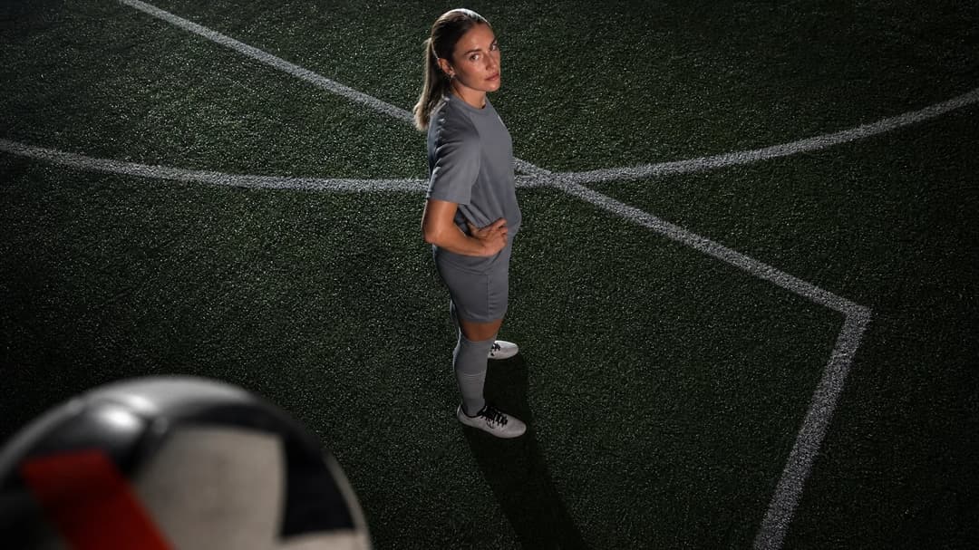 A bird's-eye view of Alexia Putellas on a football pitch, with a football in the foreground.