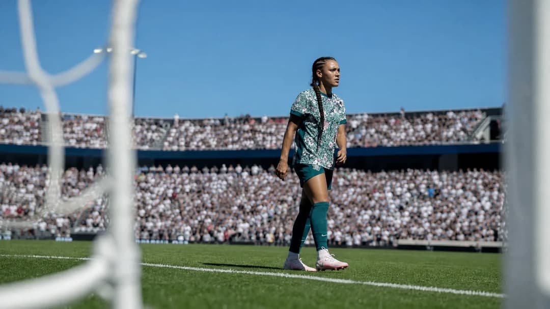 Trinity Rodman standing at the edge of the pitch, ready for the match with a focused expression.
