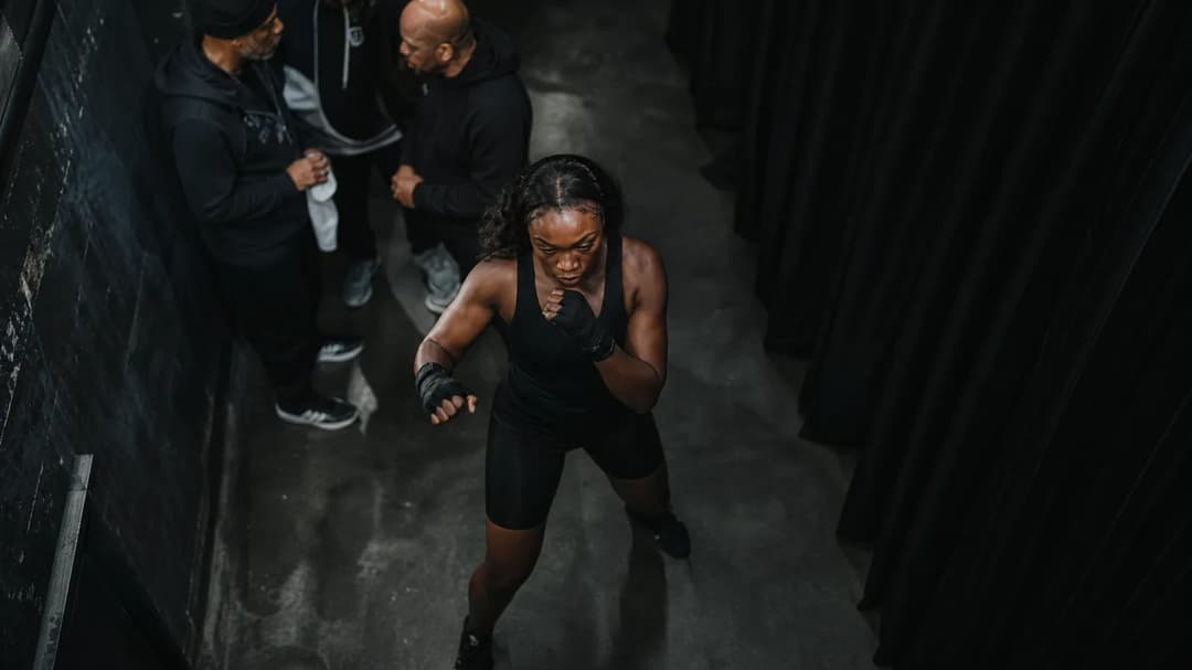 Claressa Shields warming up in a dimly lit backstage area before her title fight.