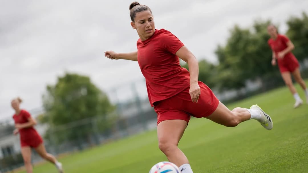 Lena Oberdorf training with teammates on a football pitch.