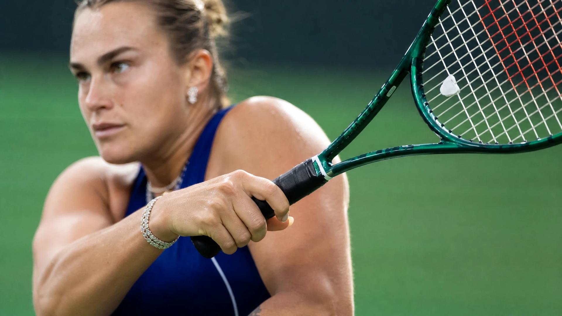 Close-up of Aryna Sabalenka's hand gripping a tennis racket during a match.