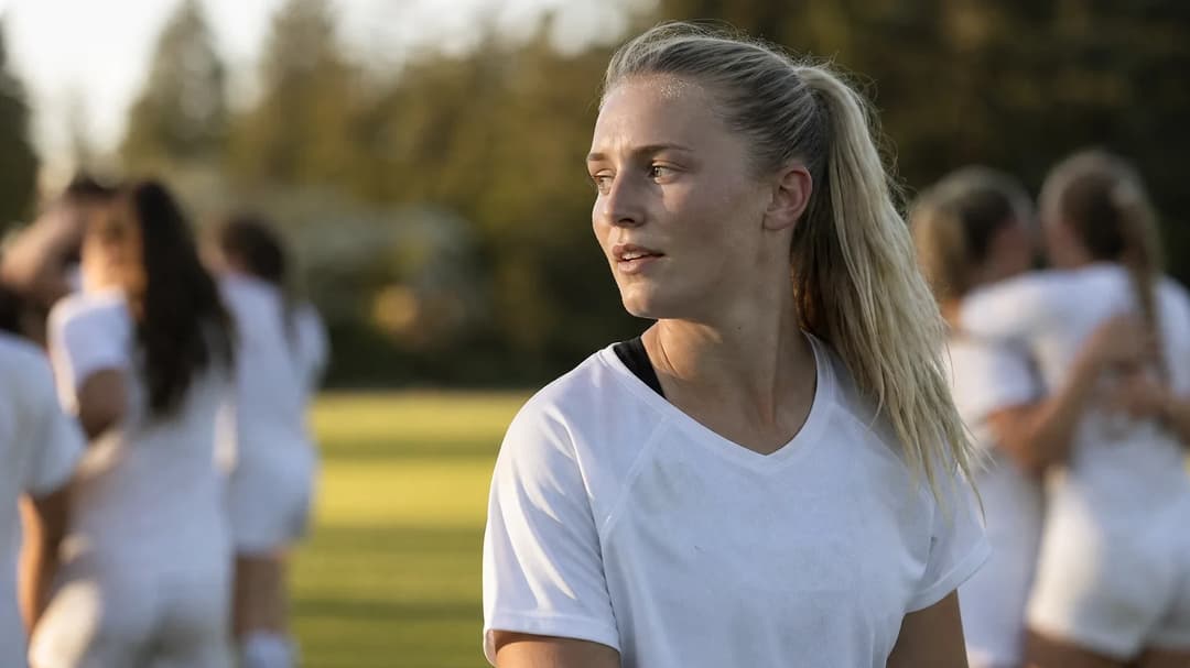 Ally Sentnor stands on a field surrounded by dappled sunlight, reflecting on a recent match.