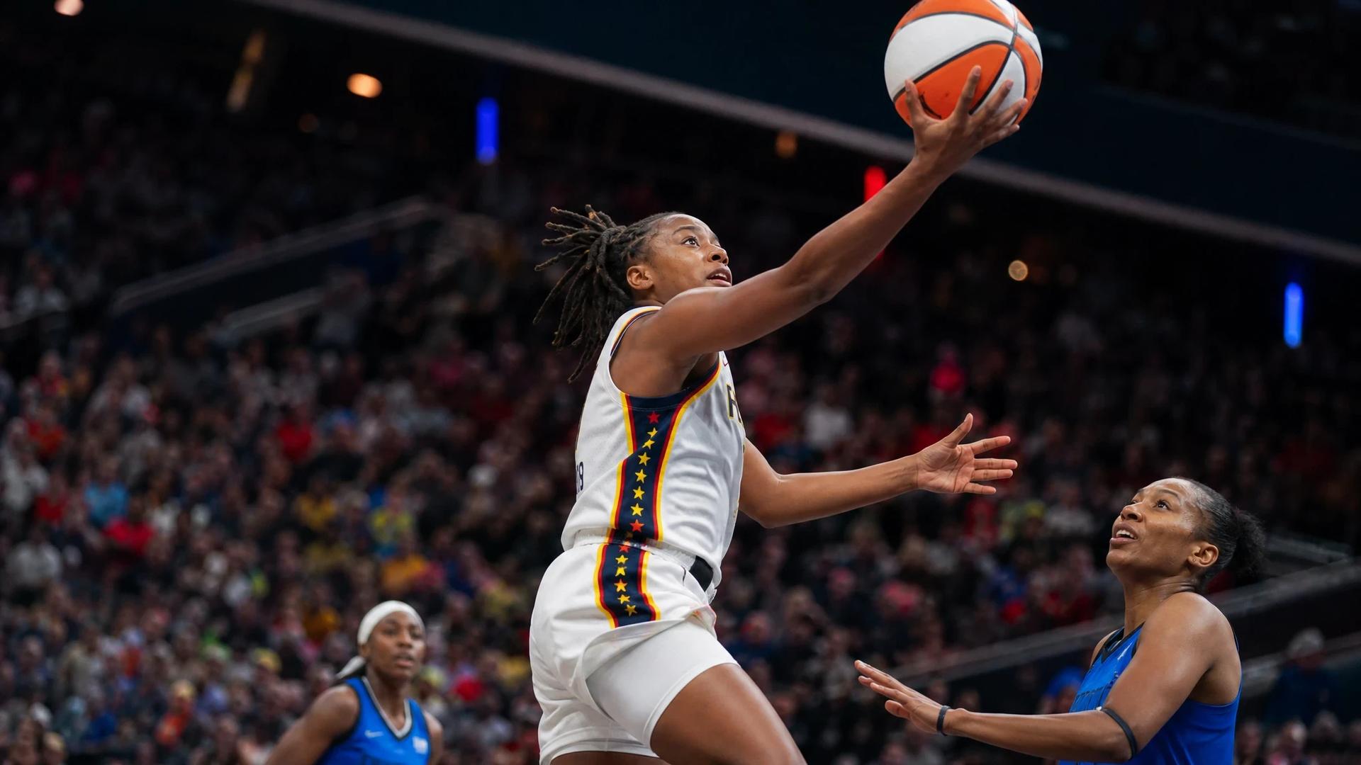 Kelsey Mitchell performing a layup in a tense basketball game.