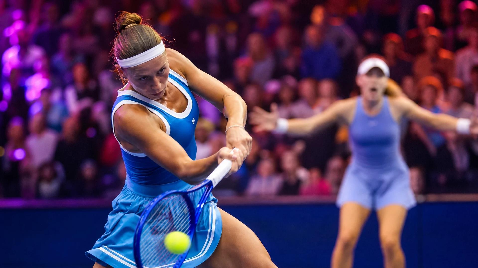 Marta Kostyuk executing a powerful forehand shot during a match.