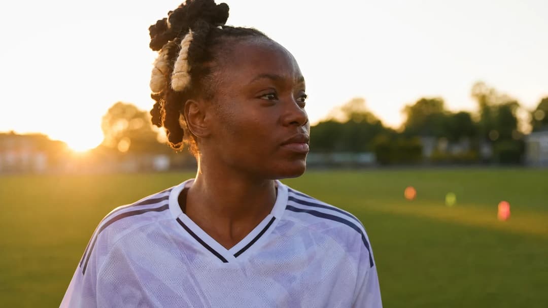 A close-up of Melvine Malard on a training pitch during sunset.