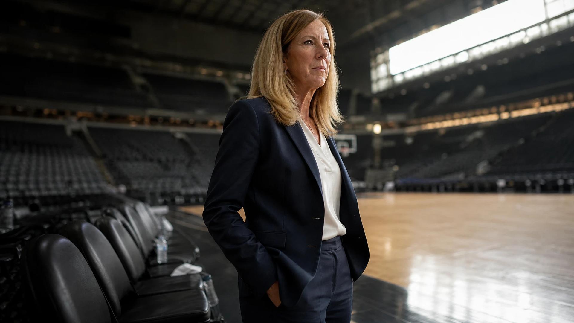 Cathy Engelbert standing in the American Airlines Center after a WNBA game, contemplative and reflective.