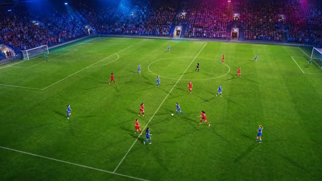 Aerial view of female football players in action on a pitch.