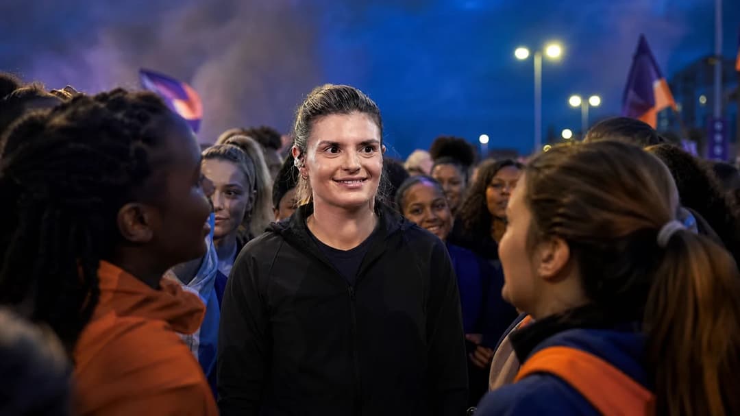 Katharina Kiel interacting with fans during a dusk event celebrating women's football.