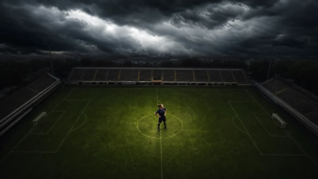 A top-down shot of a football pitch with Laura Freigang at the center, under a stormy sky.