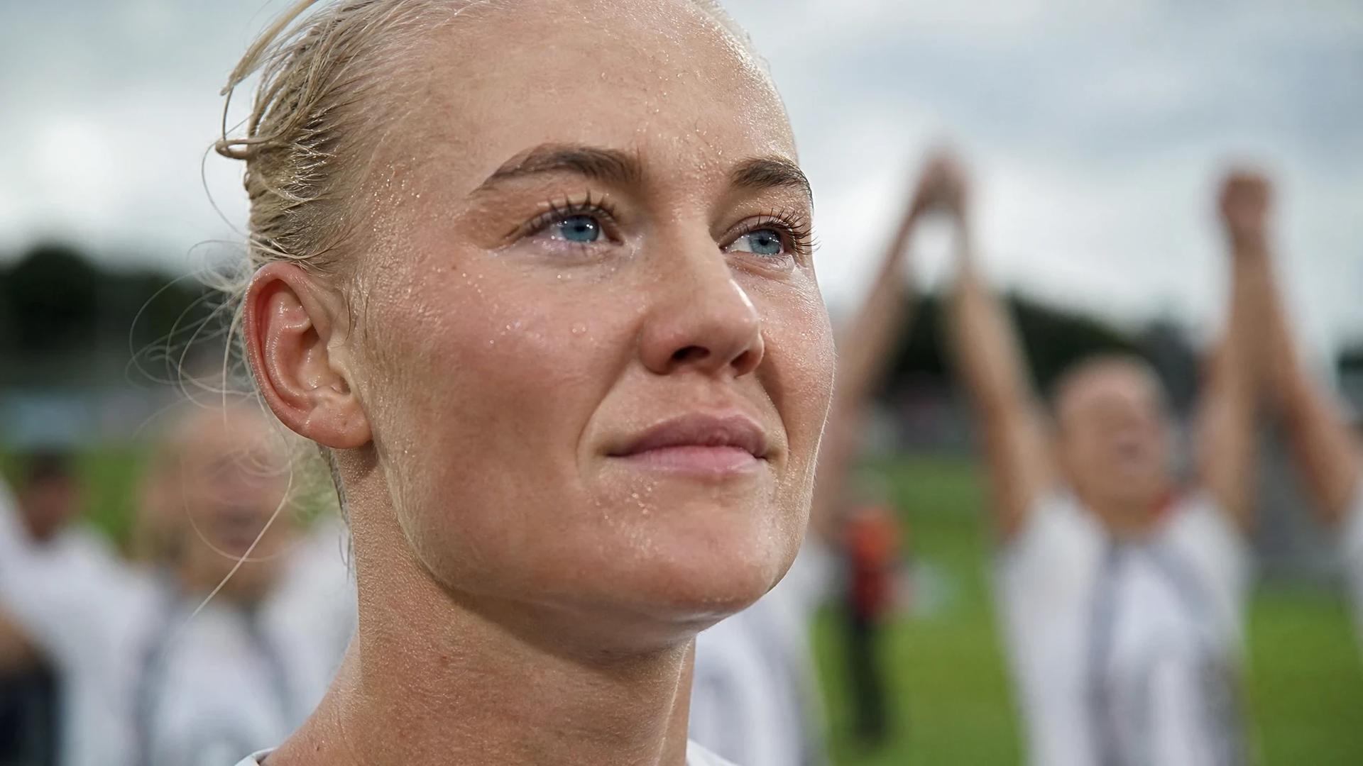 Close-up of football player Pernille Harder expressing triumph.