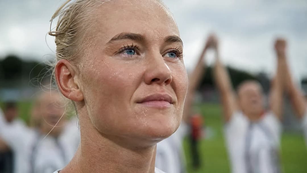 Close-up of football player Pernille Harder expressing triumph.