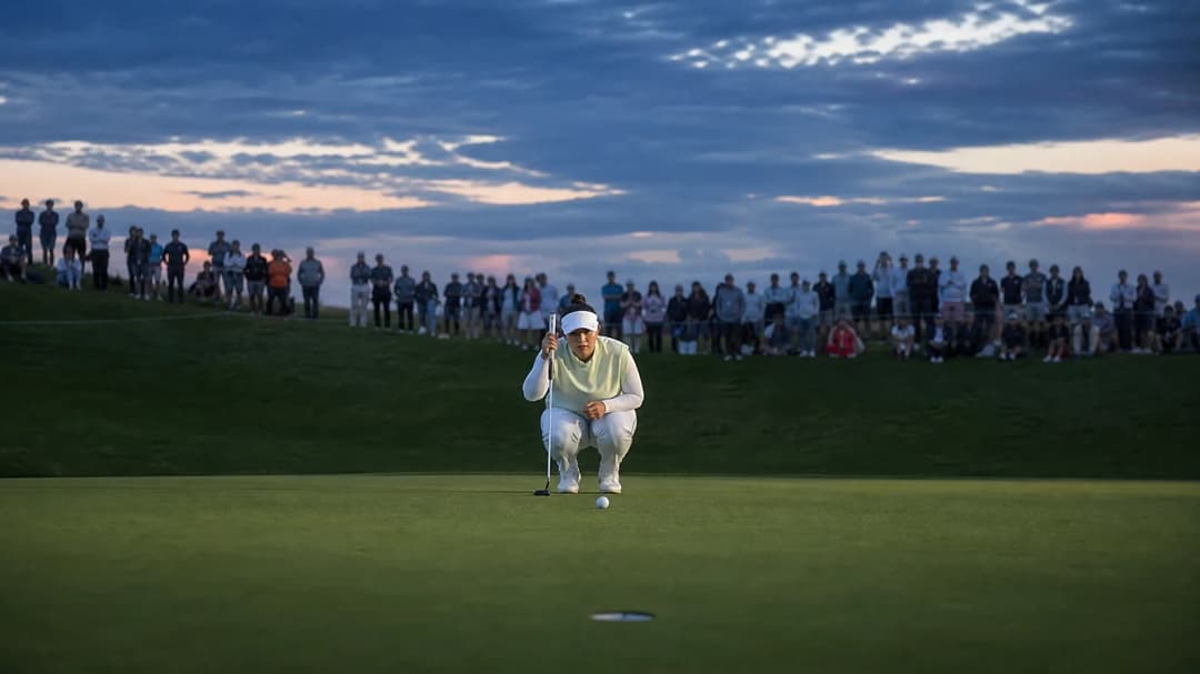 Miyu Yamashita on the golf course, preparing to take a putt at dusk.