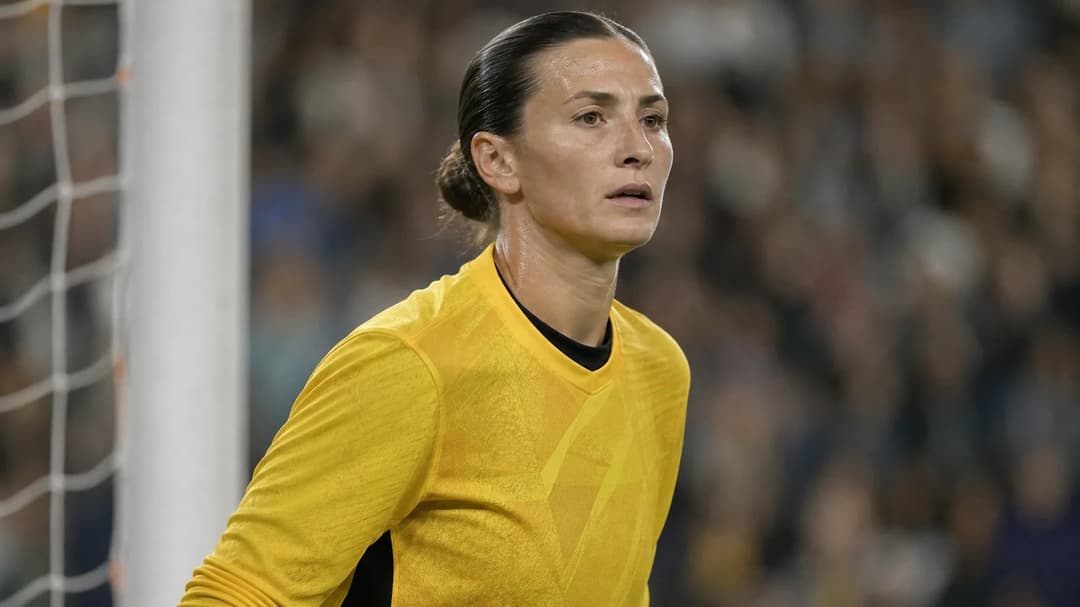 Close-up of a female goalkeeper focusing intensely as she prepares for a penalty kick.