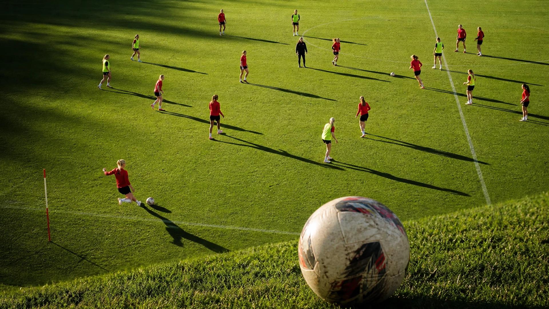 Overhead view of Liverpool Women's football team in training, with a close-up of a football.