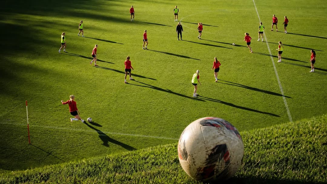 Overhead view of Liverpool Women's football team in training, with a close-up of a football.