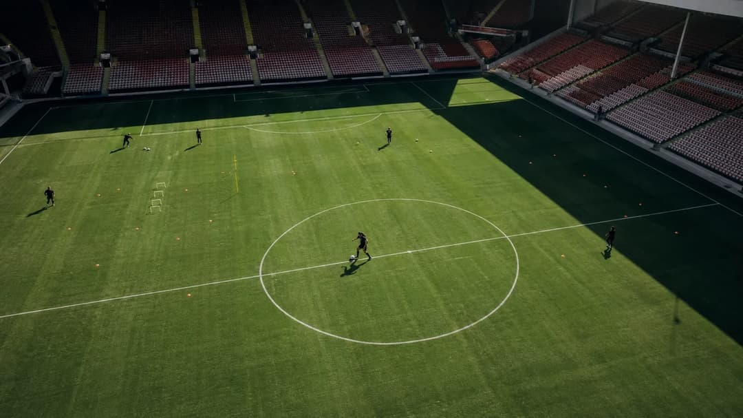 A bird's-eye view of Halle Houssein dribbling a ball on the training pitch at Bramall Lane.