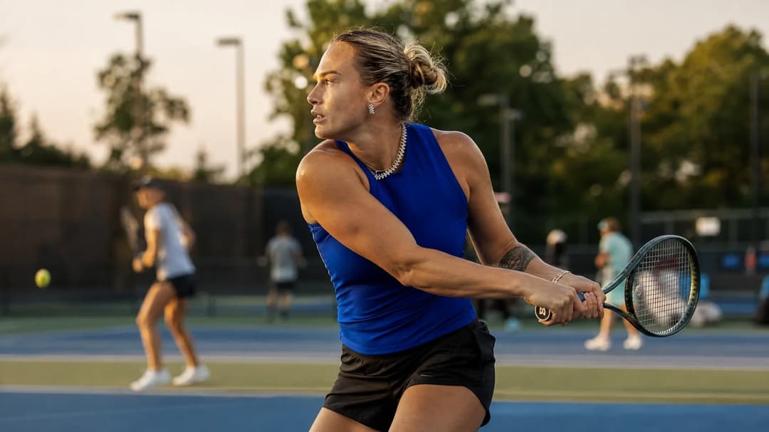 Aryna Sabalenka practicing at a tennis court, showcasing determination and focus.