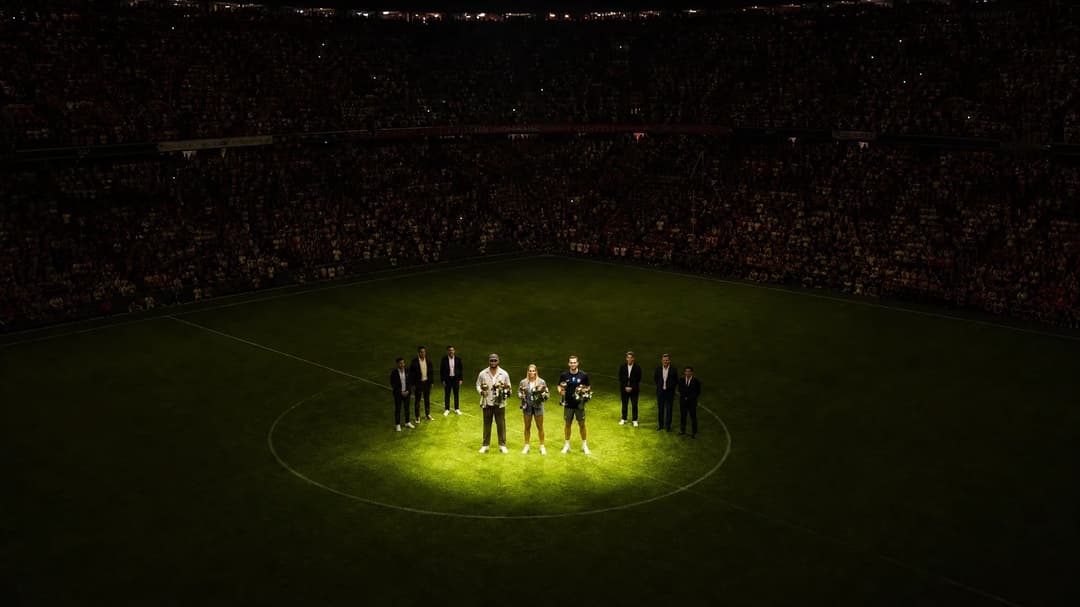 Bird's-eye view of an awards ceremony at Allianz Arena, featuring Harry Kane, Vincent Kompany, and Giulia Gwinn.