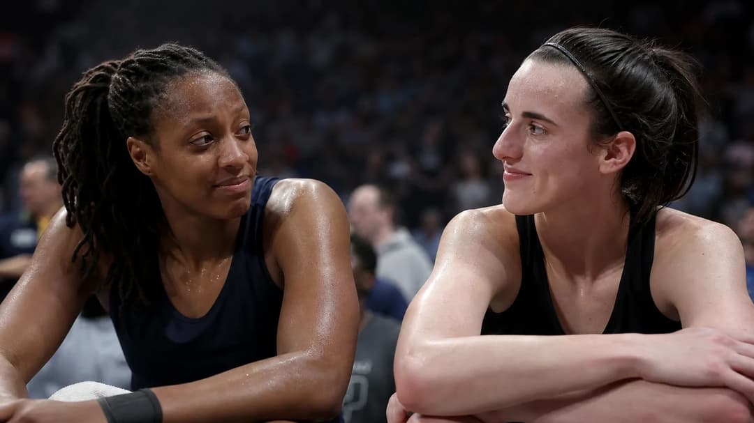 Kelsey Mitchell and Caitlin Clark share a moment of reflection on the sidelines after a WNBA game.