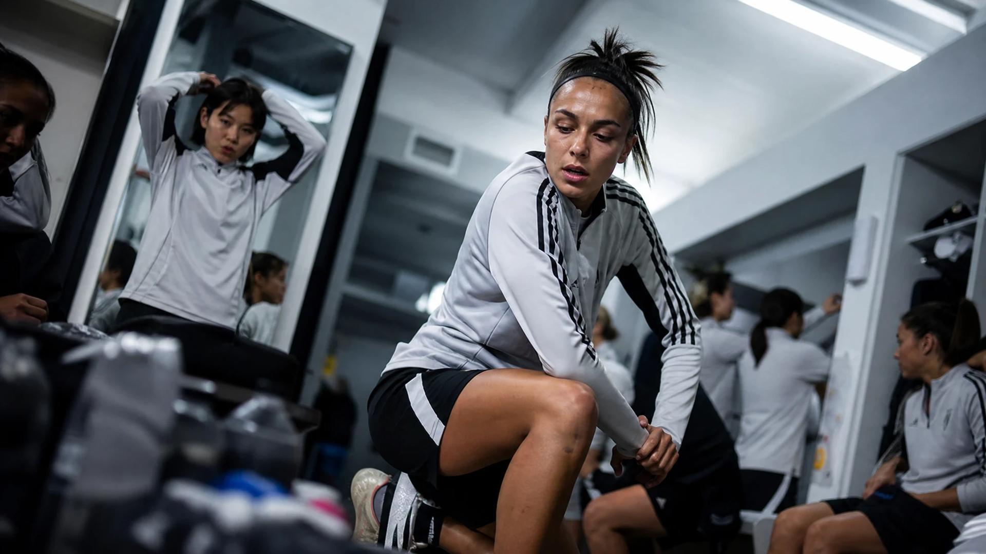 Juventus Women players prepare in the locker room before their match.