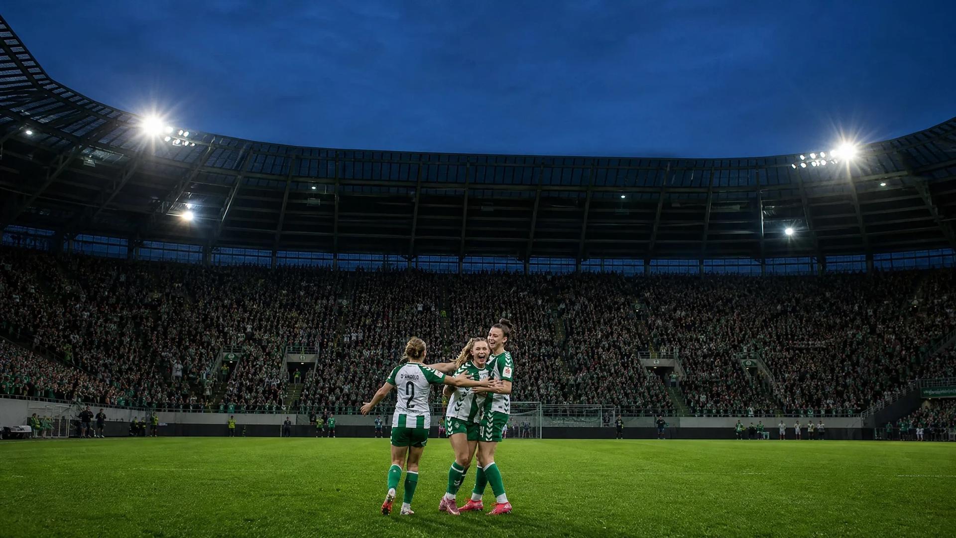Celebrating female football players at Weserstadion during a match.