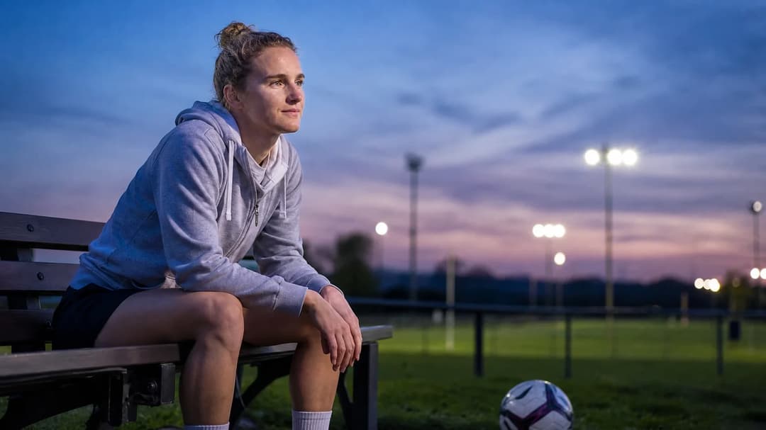 Vivianne Miedema sitting on a bench at dusk, looking thoughtful.