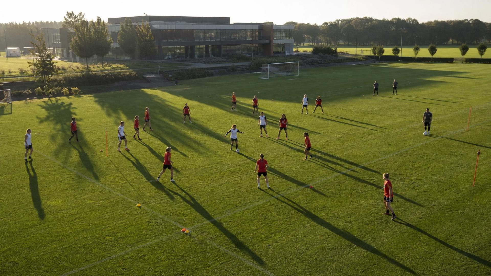 Bird's-eye view of Rebeca Bernal leading a football training session.