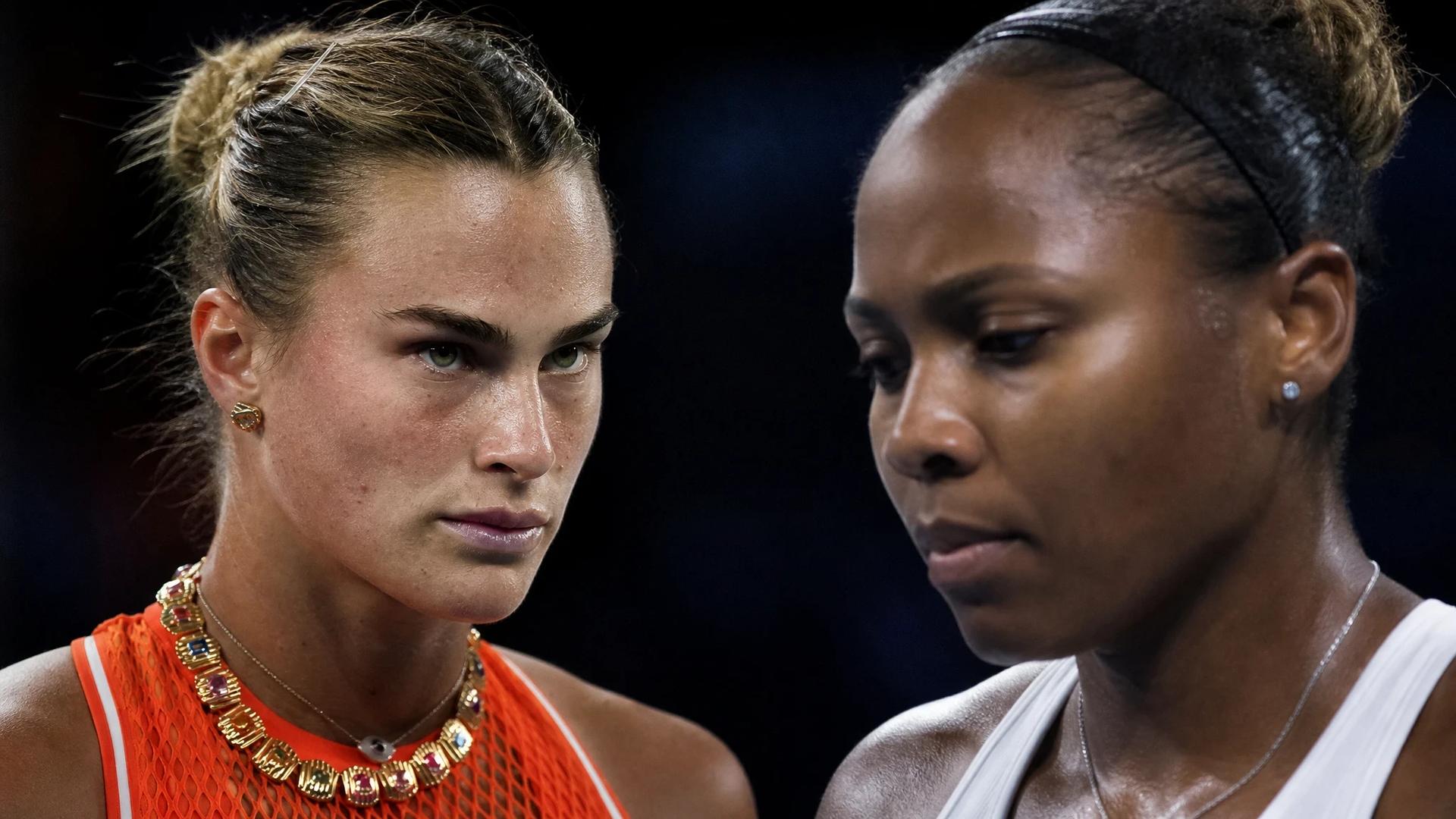 A close-up of Aryna Sabalenka and Taylor Townsend in focus during a tense moment of their match.