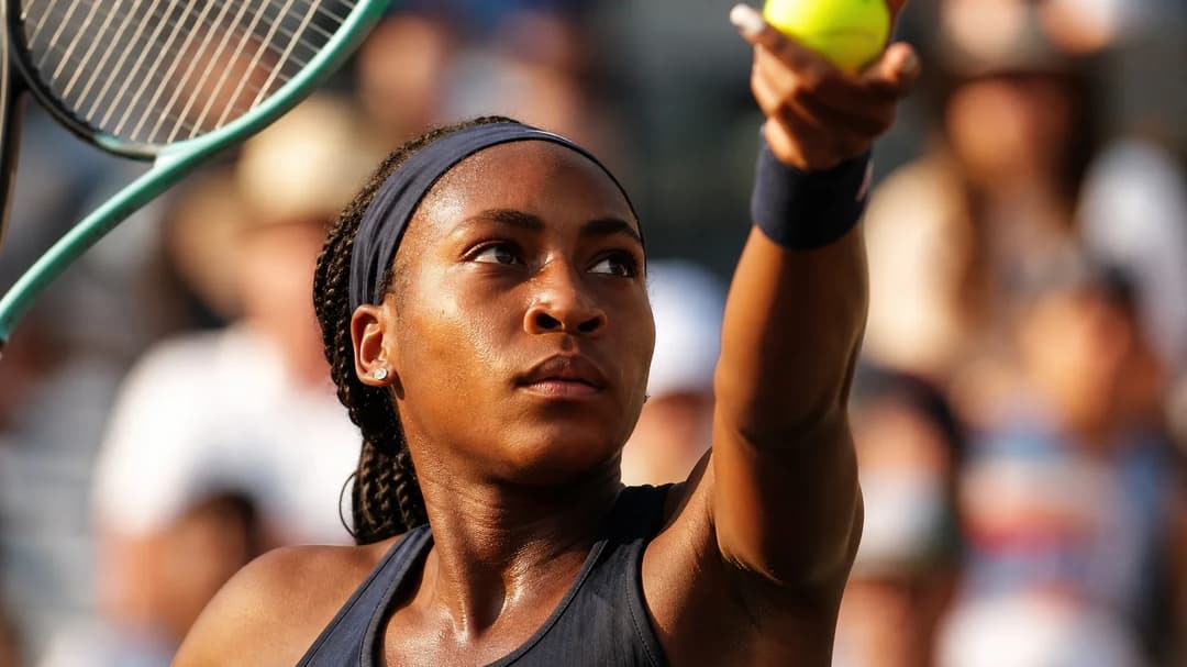 Close-up of Coco Gauff preparing to serve during a tennis match at the US Open.