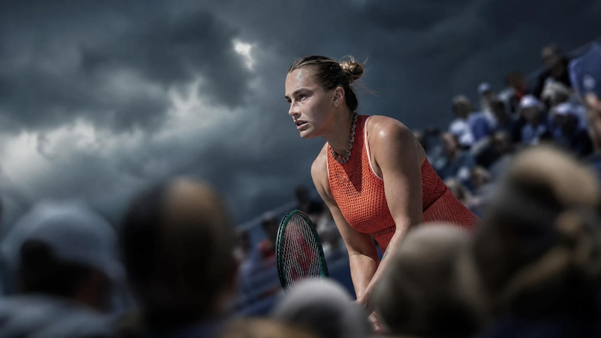 A tense moment in a tennis match between Elena Rybakina and Naomi Osaka, captured under stormy skies.