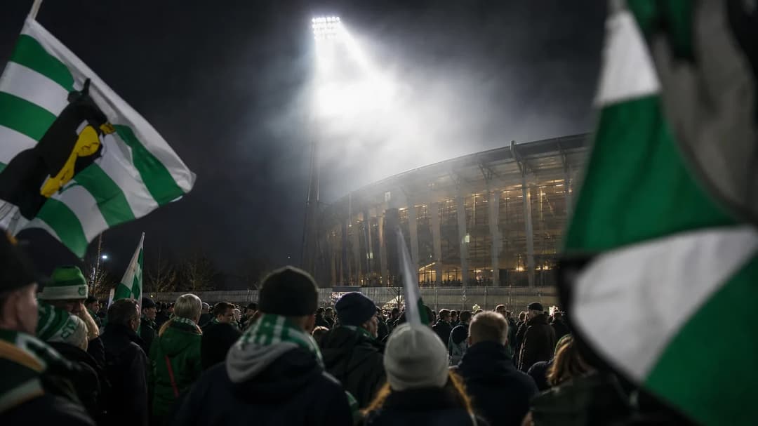 A group of Hammarby supporters gathered at a stadium entrance, holding banners in anticipation of a match.
