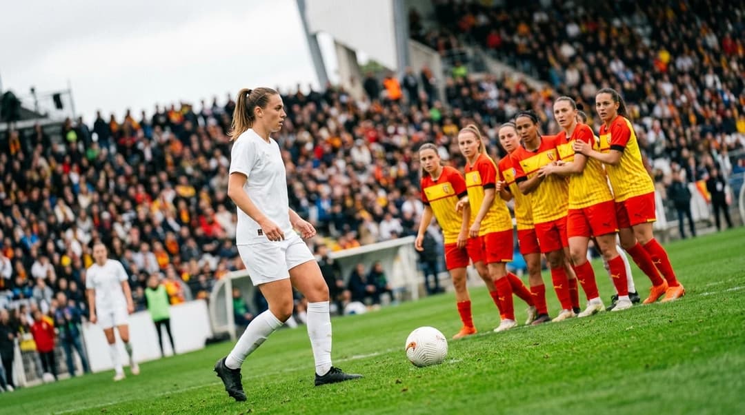 A Marseille player prepares for a free kick, surrounded by Lens players in a tense moment of the match.