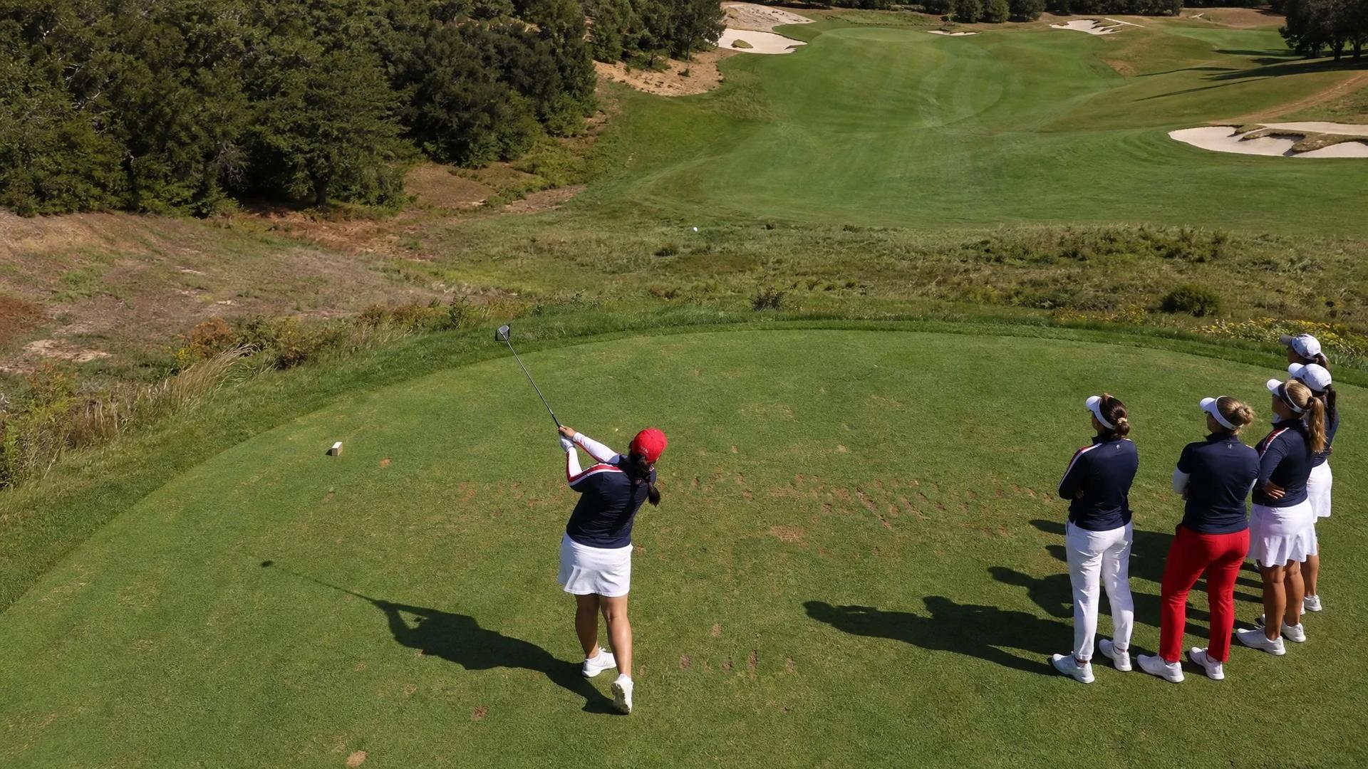 Aerial view of Angel Yin preparing to tee off at Bernardus Golf, with teammates in the background.