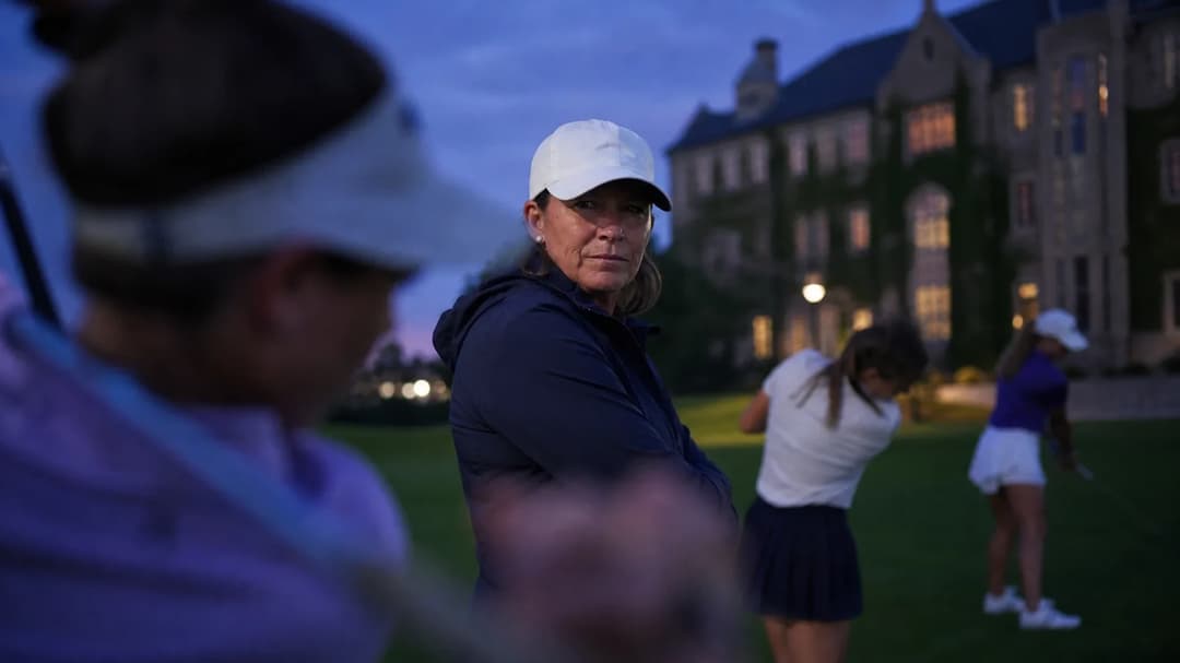 Angela Stanford watches female golfers at dusk, symbolizing her new coaching role.