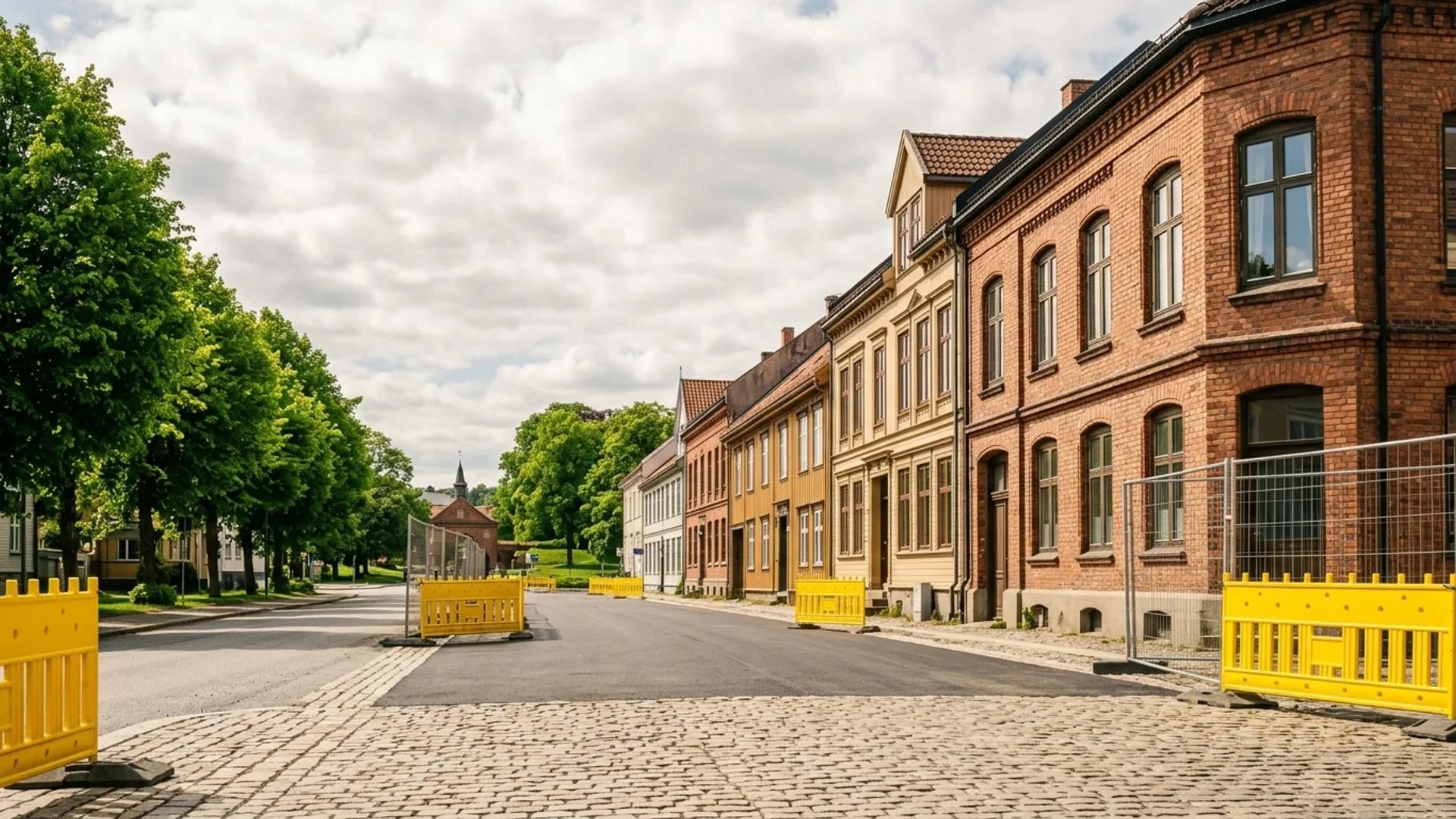 A wide angle view of the Torstrand area in Larvik, featuring buildings, roads, and construction barriers, without any people.